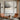 Abstract oil painting with layered gray tones, central metallic vein dividing charcoal upper zone and pale gray base, warm umber flecks and drip textures visible.
