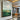 Abstract oil painting of green landscape with golden textured accents and natural earth tones.