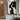Abstract minimalist painting of intertwined female faces in black and beige