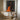 Abstract oil painting of a silhouette figure with orange drips and textured brushstrokes on black canvas background.