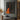Abstract oil painting of a silhouette figure with orange drips and textured brushstrokes on black canvas background.