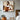 abstract minimalist painting of a woman seated in earth tones and white