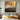 Original oil painting of mountain range with gold accents and textured sky in earthy tones