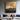 Original oil painting of mountain range with gold accents and textured sky in earthy tones