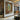 Impressionist Interior Oil Painting with Books, Bottles, and Sunlit Window