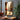 Hand-painted impressionist oil painting of a woman in white sitting on a Paris street with the Eiffel Tower, romantic golden tones and poetic urban scene