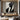 Minimalist oil painting of a black geometric suit silhouette with angular facial planes and diagonal composition on ivory background.
