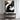 "Minimalist Plane" 2D abstract oil painting featuring a composition of flat geometric and organic shapes in black, white, grey, and touches of gold, in a contemporary minimalist style.