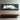 Panoramic Minimalist Oil Painting of White Sleeping Cat on Blue Background