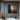 Abstract minimalist oil painting with a soft glow emerging from a dark, textured canvas