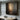 Abstract minimalist oil painting with a soft glow emerging from a dark, textured canvas