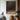 "Umbral Light" abstract oil painting featuring textured white, beige, and luminous gold/orange forms emerging from a dark brown and black background.