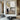 Minimalist abstract painting with a lone figure in a soft gray and beige city scene