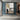 Minimalist abstract painting with a lone figure in a soft gray and beige city scene
