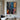 Abstract oil painting with explosive color splashes in white, blue, orange, and pink intersecting on black textured canvas.  