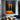 Abstract oil painting of two glowing orange human silhouettes standing vertically against a dark charcoal background with mirrored reflections.