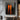 Abstract oil painting of two tall orange silhouettes with mirrored reflections, standing against a deeply textured charcoal-black background.  