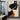 Abstract female figure with black orange and beige curves on a minimalist background