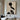 Abstract oil painting of a female silhouette with black profile, white fabric accents, and textured beige background in minimalist style.  
