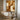 Abstract geometric oil painting with angular white shapes contrasting against rich brown textures, visible brushstrokes on linen canvas, modern earth tone artwork.?