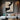 Abstract oil painting depicting a human silhouette through fluid black and white curves, set against a textured beige canvas with visible brushstrokes.?
