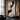 Abstract oil painting depicting a human silhouette through fluid black and white curves, set against a textured beige canvas with visible brushstrokes.?