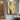 Abstract minimalist painting with two intertwined faceless figures in beige and caramel tones