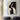 Abstract minimalist painting of intertwined female faces in black and beige