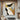 Modern abstract oil painting with gold leaf textures intersecting bold black geometric shapes and taupe grey accents on white linen canvas.