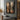 Abstract oil painting of symmetrical hourglass forms with woodgrain textures in beige and brown tones, transitioning to black gradient background.  