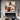 abstract minimalist painting of a woman seated in earth tones and white