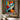 "Azure & Citrus Gaze" abstract pop art painting of a fragmented face with glossy finish, in bold orange, blue, black, and white, with prominent red lips.
