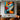 "Azure & Citrus Gaze" abstract pop art painting of a fragmented face with glossy finish, in bold orange, blue, black, and white, with prominent red lips.
