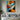 "Azure & Citrus Gaze" abstract pop art painting of a fragmented face with glossy finish, in bold orange, blue, black, and white, with prominent red lips.
