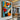 "Azure & Citrus Gaze" abstract pop art painting of a fragmented face with glossy finish, in bold orange, blue, black, and white, with prominent red lips.
