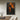Abstract silhouette oil painting of woman in black with fiery orange background, expressive emotional hand-painted canvas wall art