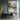 Metallic abstract cityscape painting with golden lights and water reflections