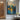 Hand-painted cityscape with yellow sunset and blue skyline in oil