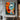 "Dual Essence" abstract portrait oil painting of a fragmented face with one open and one closed eye, using bold blocks of orange, blue, black, and white with red lips.
