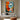 "Dual Essence" abstract portrait oil painting of a fragmented face with one open and one closed eye, using bold blocks of orange, blue, black, and white with red lips.
