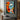 "Dual Essence" abstract portrait oil painting of a fragmented face with one open and one closed eye, using bold blocks of orange, blue, black, and white with red lips.
