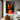 Abstract painting of two orange human silhouettes against black background