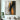 "Gilded Spires" abstract oil painting featuring textured vertical strokes of black and metallic gold/bronze against a grey and white background, creating a dramatic, modern effect.
