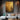 Abstract gold oil painting with raised grid texture and charcoal accents on stretched canvas, creating light-reflective metallic effects.  