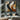 Abstract geometric oil painting with flowing golden, black and beige wave-like forms
