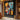 "Neon Velocity" abstract oil painting in a pop art and graffiti style, featuring vibrant streaks of neon-like colors (yellow, red, blue) over a dark, abstracted urban background.
