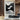 Abstract oil painting with wave-like flowing white lines over black background