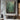 Textured abstract oil painting featuring layered green earth tones, brown geological patterns