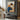 Hand-painted figurative oil painting of a relaxed woman in earth tone interior