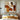 minimalist abstract painting of a seated woman in warm beige and brown tones